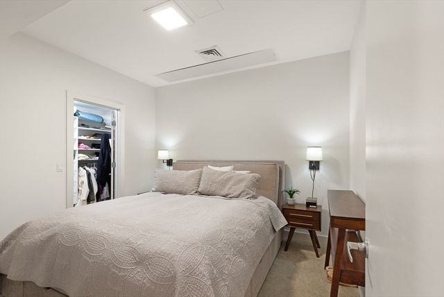 a bedroom with a bed and a table