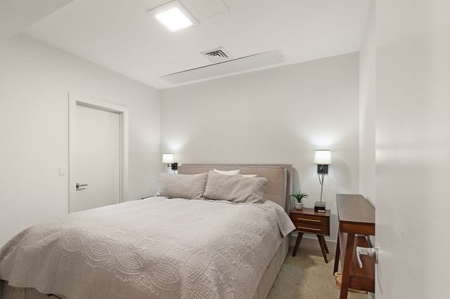 a bedroom with a bed and chair