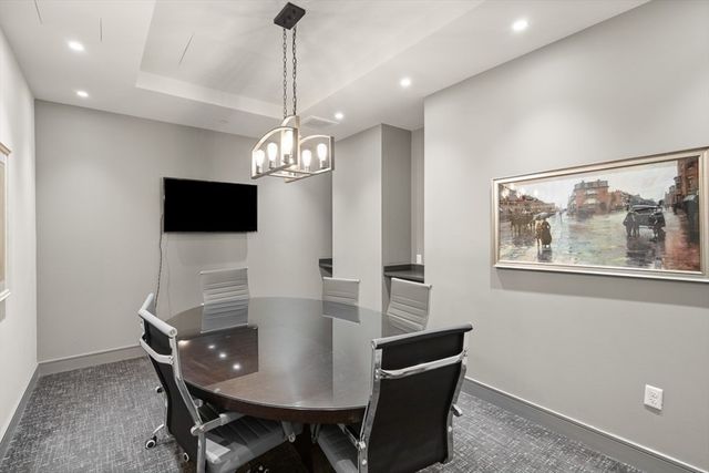 a dining room with furniture a chandelier and window