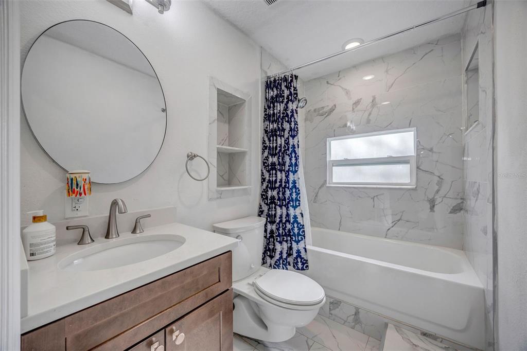 7149 Spruce Drive Weeki Wachee, FL 34607 - Photo 14 of 23 a bathroom with a sink toilet and shower