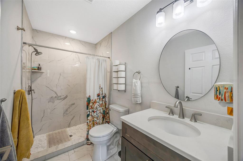 7149 Spruce Drive Weeki Wachee, FL 34607 - Photo 18 of 23 a bathroom with a sink toilet and shower