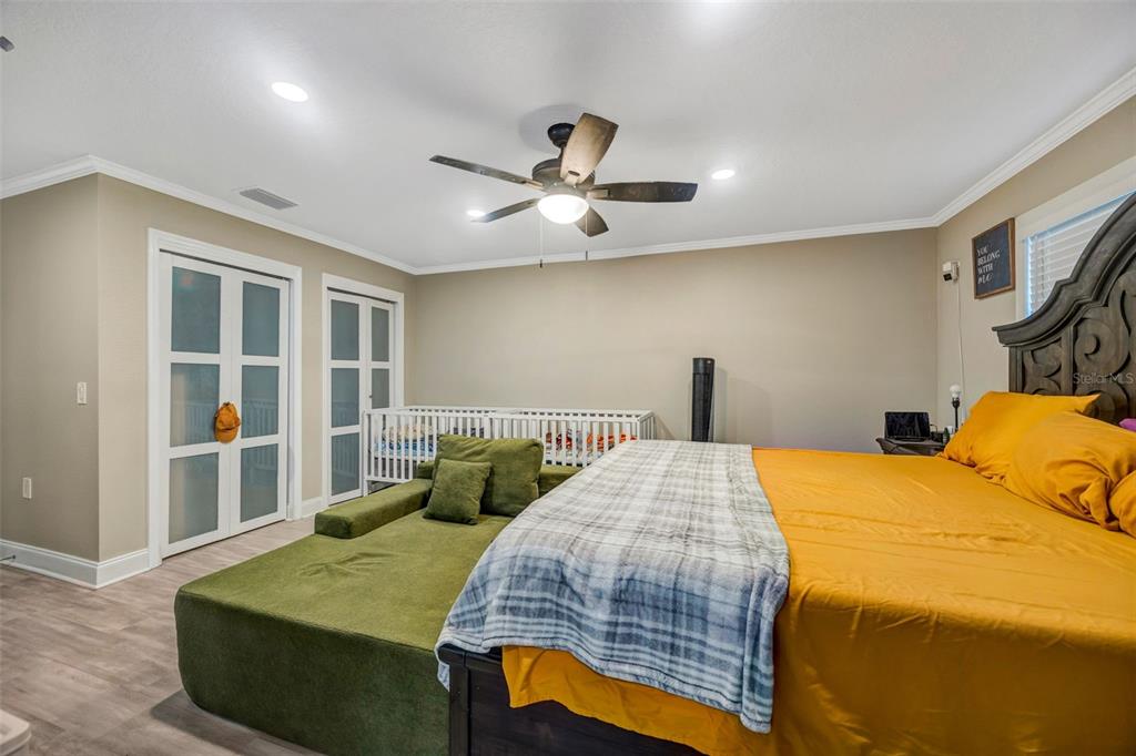 7149 Spruce Drive Weeki Wachee, FL 34607 - Photo 7 of 23 a bedroom with a bed and a chandelier