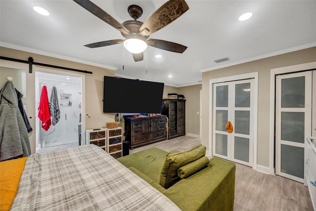 7149 Spruce Drive Weeki Wachee, FL 34607 - Photo 8 of 23 a living room with furniture and a flat screen tv