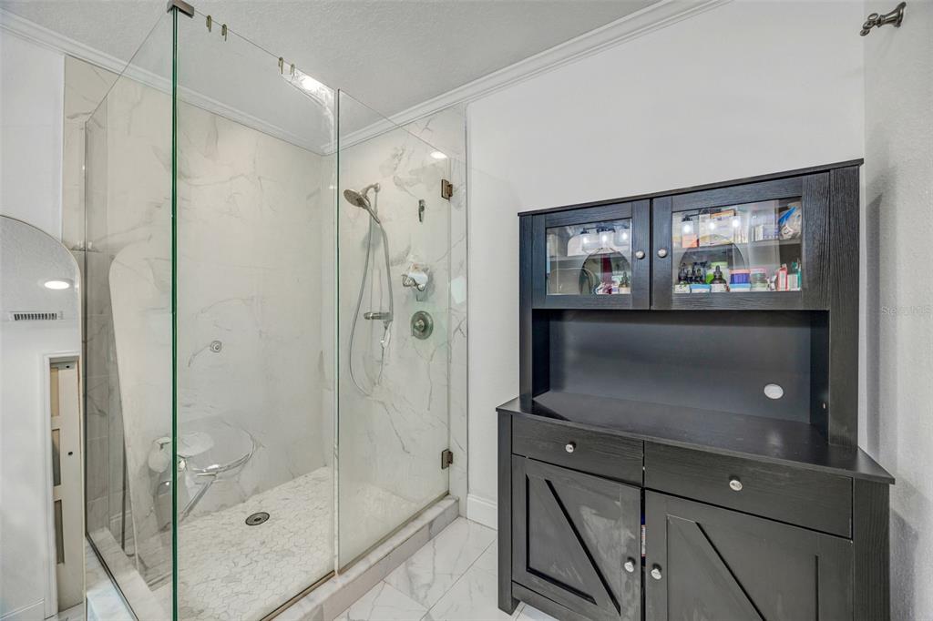 7149 Spruce Drive Weeki Wachee, FL 34607 - Photo 10 of 23 a bathroom with a shower sink and mirror