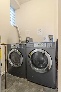a utility room with sink dryer and washer