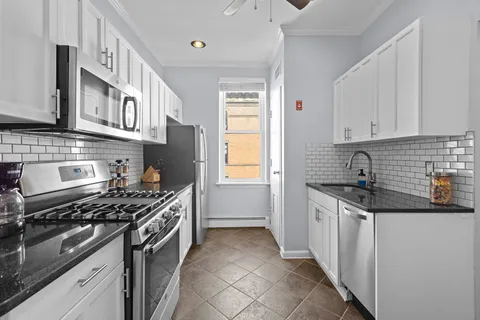 a kitchen with stainless steel appliances granite countertop a stove and a sink