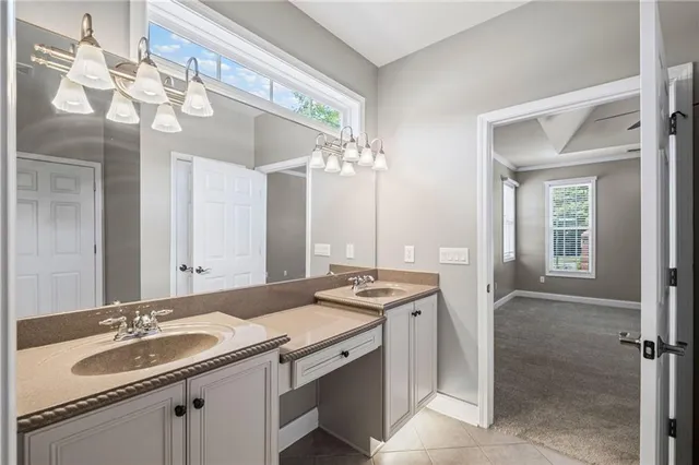 a bathroom with a granite countertop sink a large mirror and a shower