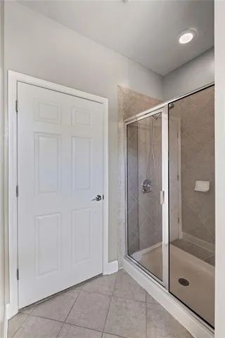 a bathroom with a glass shower door