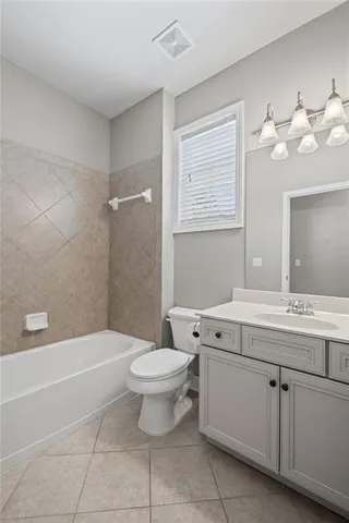 a bathroom with a sink a toilet and bathtub