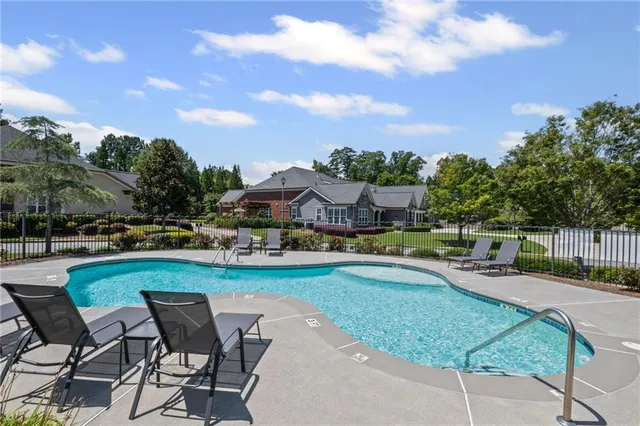 an outdoor space with swimming pool and furniture