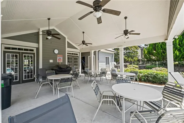 a dining room with furniture a chandelier and a floor to ceiling window
