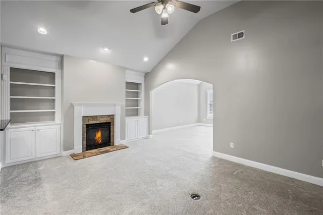 a view of an empty room with a fireplace