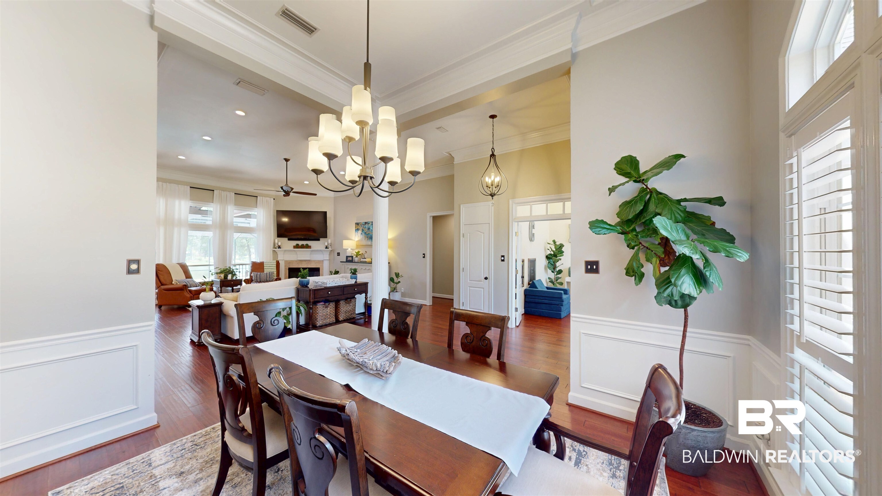 8775 Dawes Lake Road North Mobile, AL 36619 - Photo 15 of 59 Dining room with a decorative wall, wainscoting, wood finished floors, ornamental molding, and a fireplace