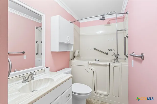 a bathroom with a sink a toilet a mirror and shower