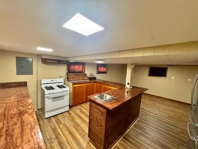 a kitchen with stainless steel appliances granite countertop a stove a sink and a refrigerator