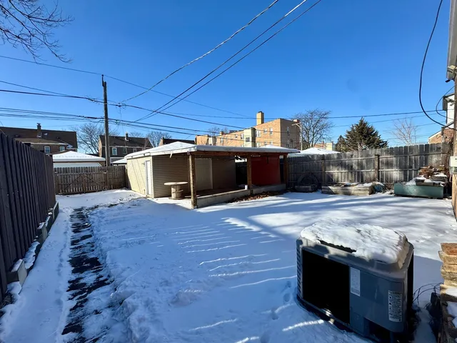 a view of a patio with table and chairs with wooden floor and fence