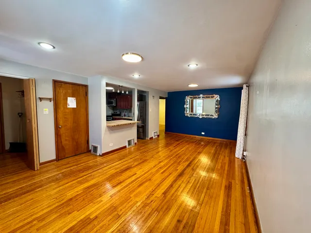 a view of an empty room with closet and entryway