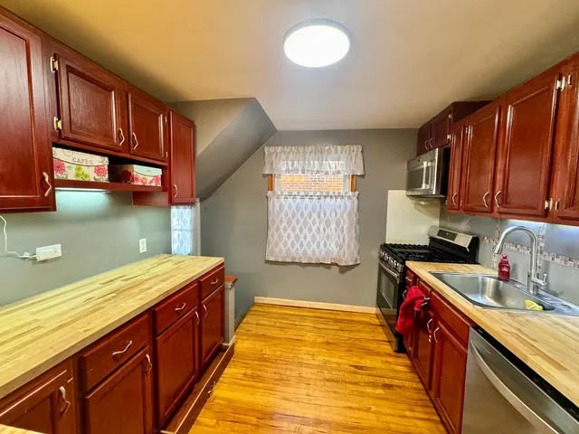 a kitchen with stainless steel appliances granite countertop a sink stove and cabinets