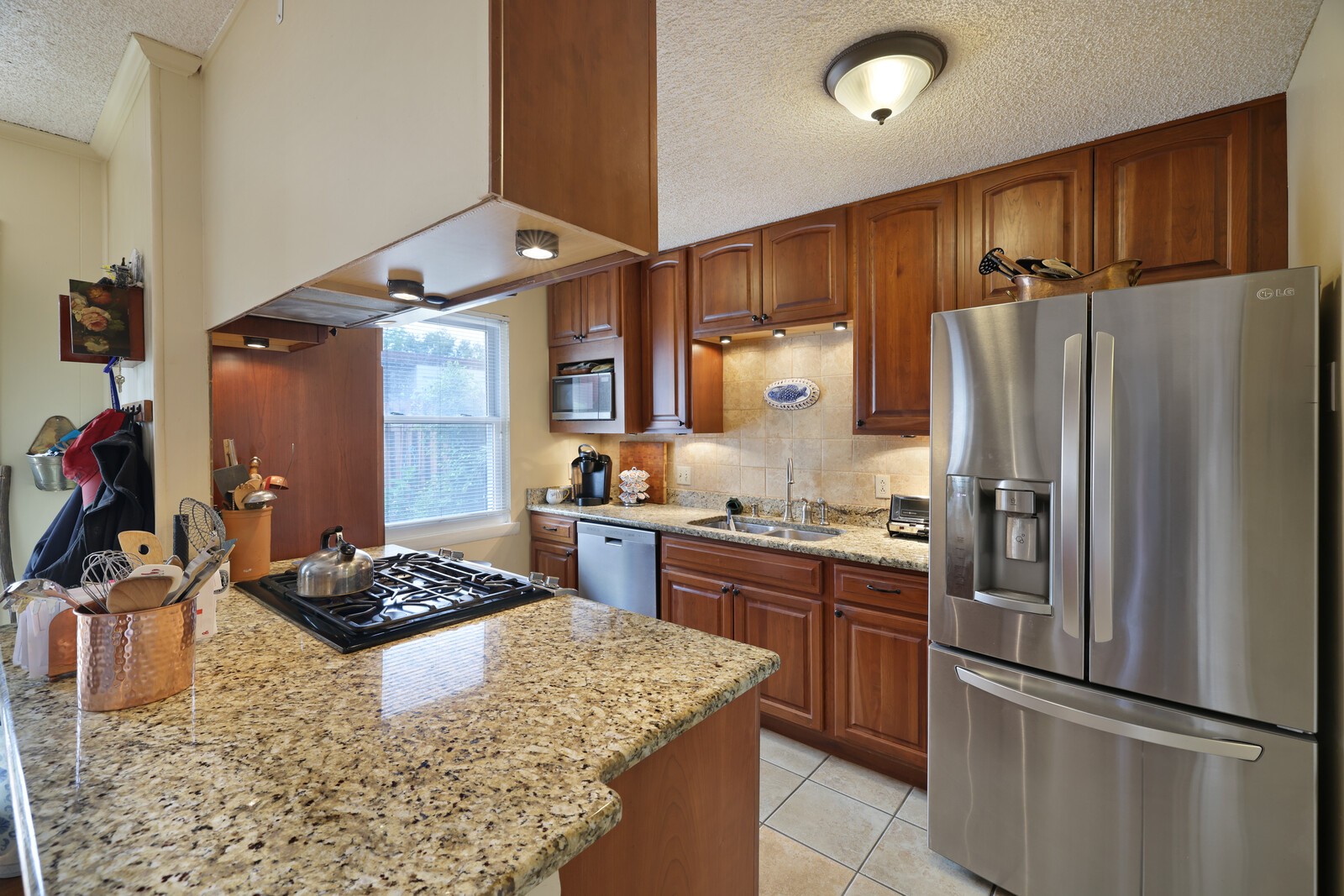 4001 Anderson Road, Unit K24 Nashville, TN 37217 - Photo 11 of 36 a kitchen with stainless steel appliances granite countertop a sink stove and refrigerator