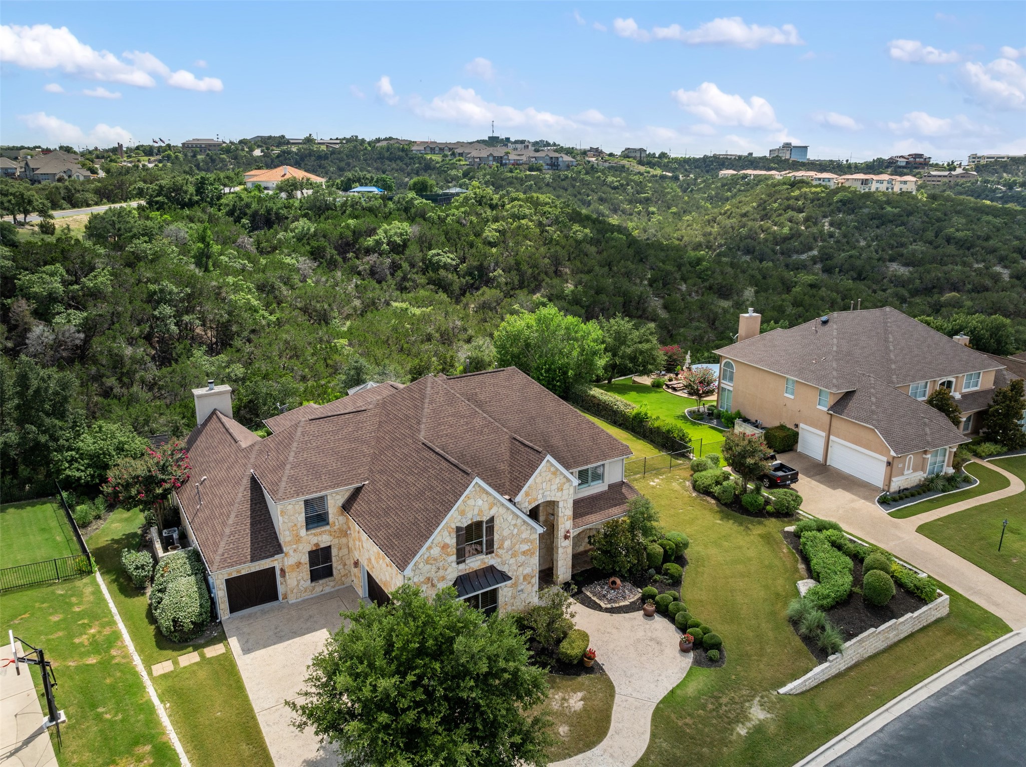 an aerial view of multiple houses with a yard