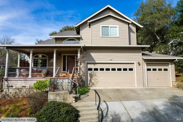 a front view of a house with a yard garage and outdoor seating