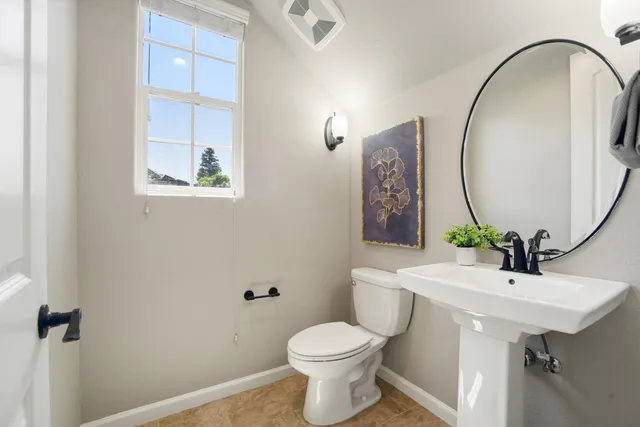 a bathroom with a sink toilet and a mirror