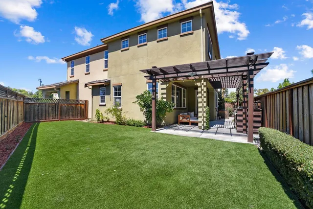 a view of a house with backyard and porch