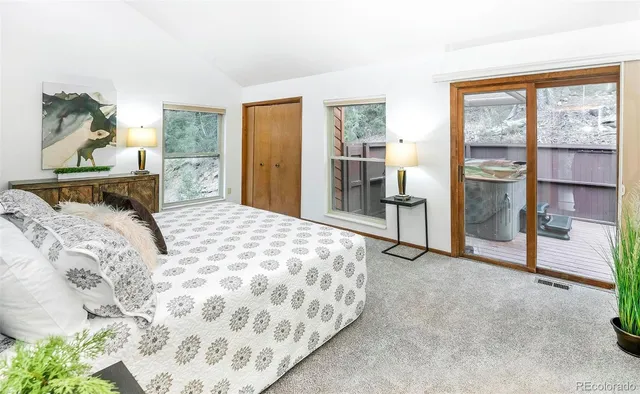 a bedroom with a large bed and a window