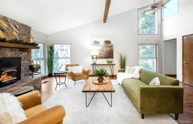 a living room with furniture a fireplace and a flat screen tv