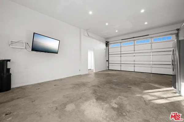 a living room with furniture and a dining table with kitchen view