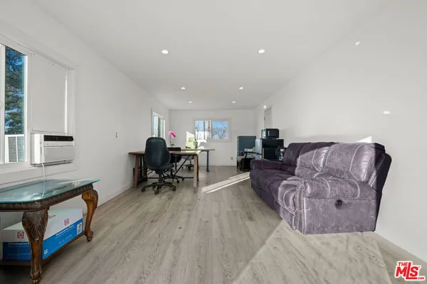 an empty room with a cabinet and mirrors