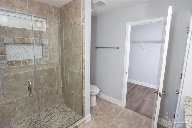 a bathroom with a shower and toilet