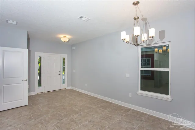 a view of a room with wooden floor and chandelier