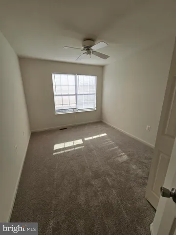 a view of a big room with closet and ceiling fan