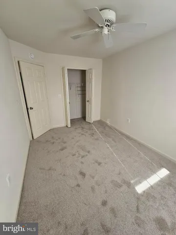 a view of a room with a ceiling fan