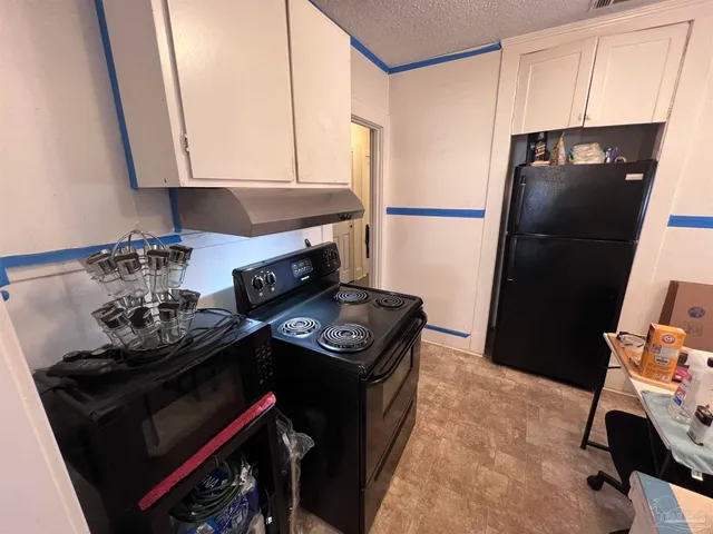 a kitchen with a stove and a refrigerator