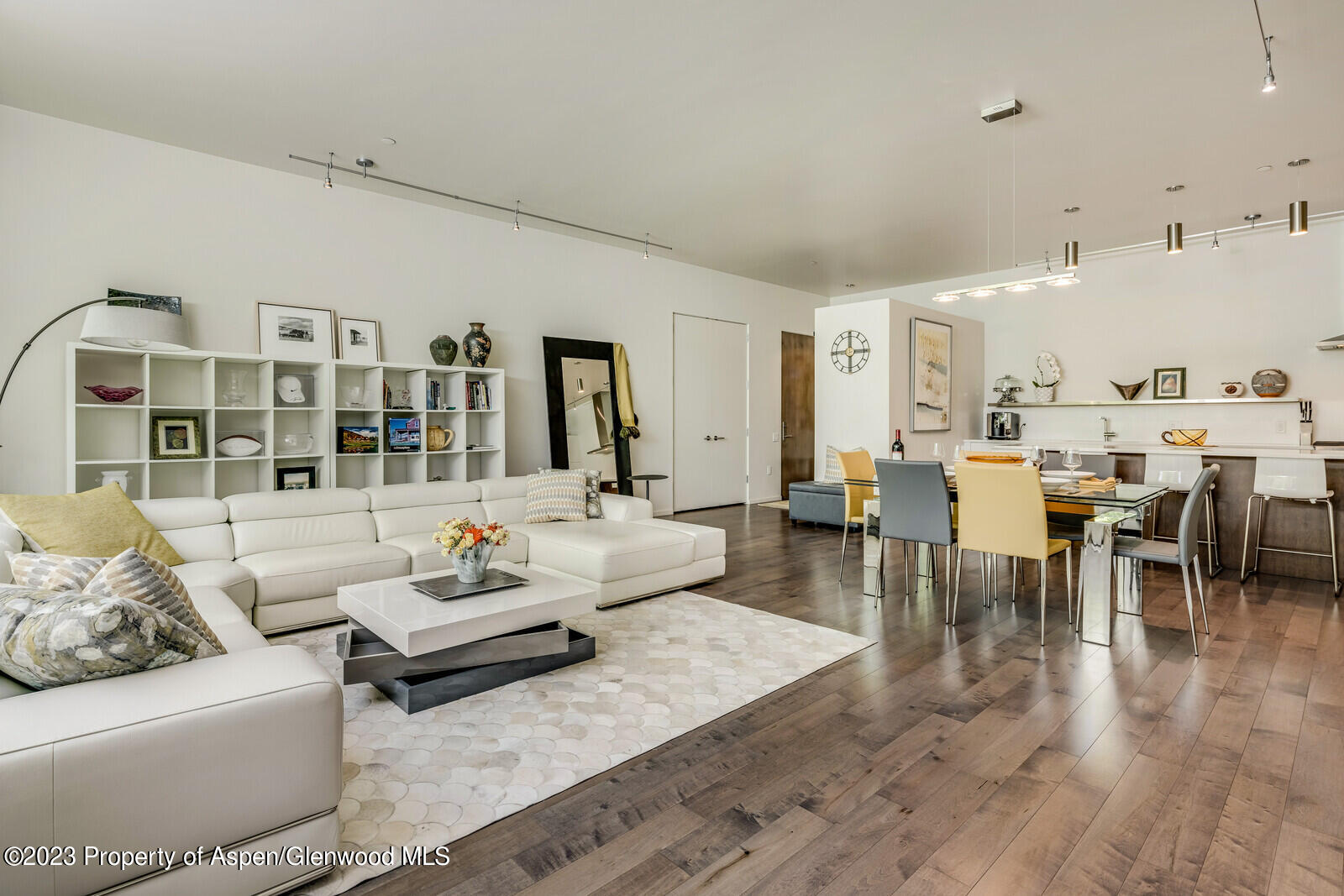 a living room with lots of furniture and view of kitchen