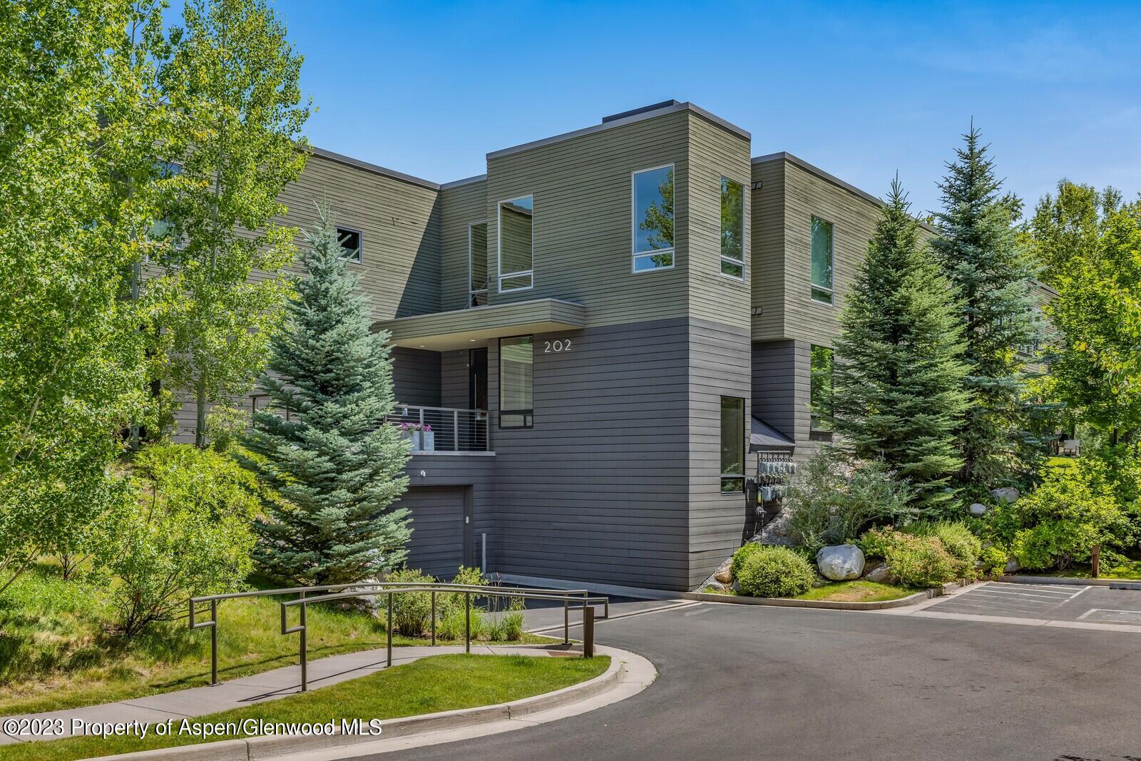 202 Evans Road, Unit 105 Basalt, CO 81621 - Photo 2 of 27 a front view of a house with a yard garage and outdoor seating