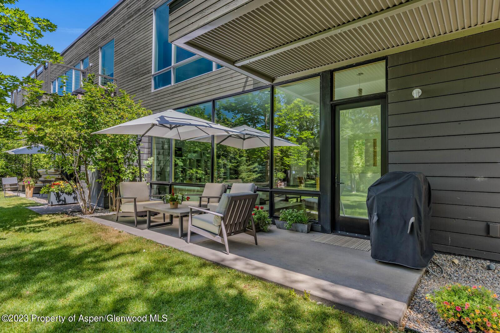 202 Evans Road, Unit 105 Basalt, CO 81621 - Photo 10 of 27 a view of chairs and table under an umbrella