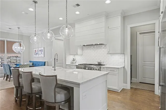 a large kitchen with a table and chairs