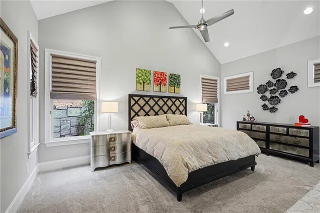 a bedroom with a large bed and a window