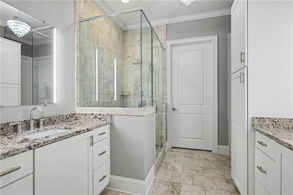 317 Riversedge Drive Atlanta, GA 30339 - Photo 20 of 49 a bathroom with a granite countertop sink a mirror and a shower