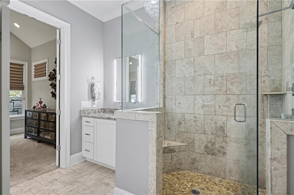 317 Riversedge Drive Atlanta, GA 30339 - Photo 21 of 49 a bathroom with a granite countertop sink a mirror and shower