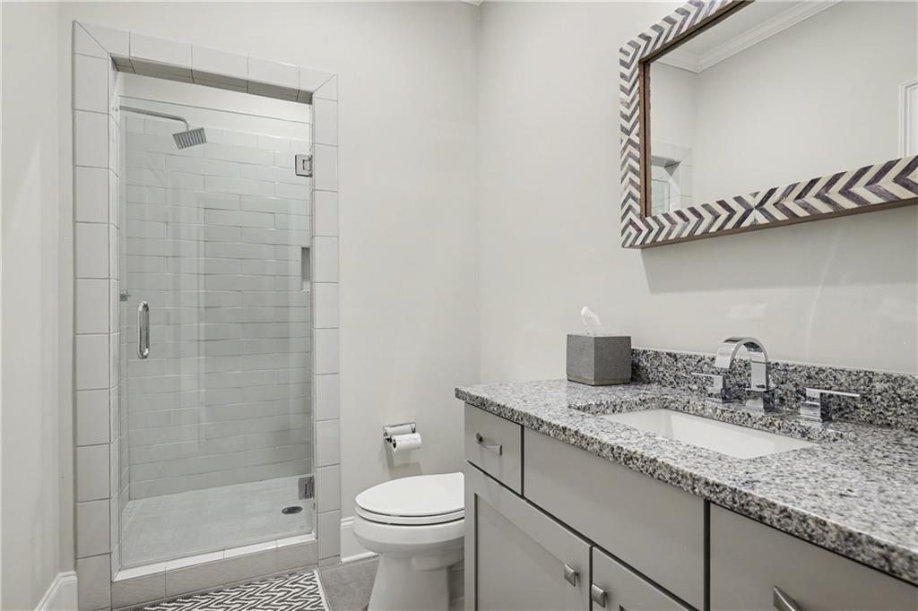 317 Riversedge Drive Atlanta, GA 30339 - Photo 23 of 49 a bathroom with a granite countertop sink a toilet and shower