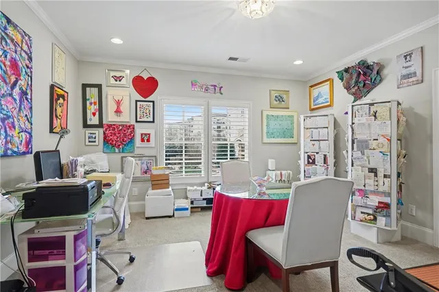 a living room with furniture a flat screen tv and a table