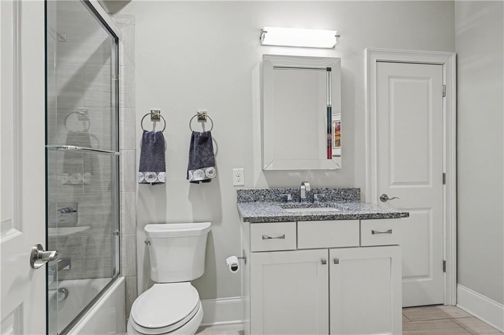 317 Riversedge Drive Atlanta, GA 30339 - Photo 29 of 49 a bathroom with a granite countertop toilet sink and mirror