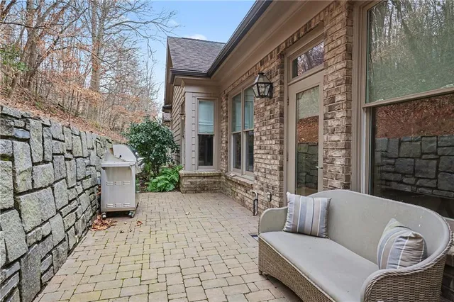 a balcony with furniture and a potted plant