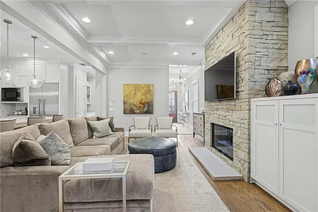 a living room with furniture a fireplace and a flat screen tv