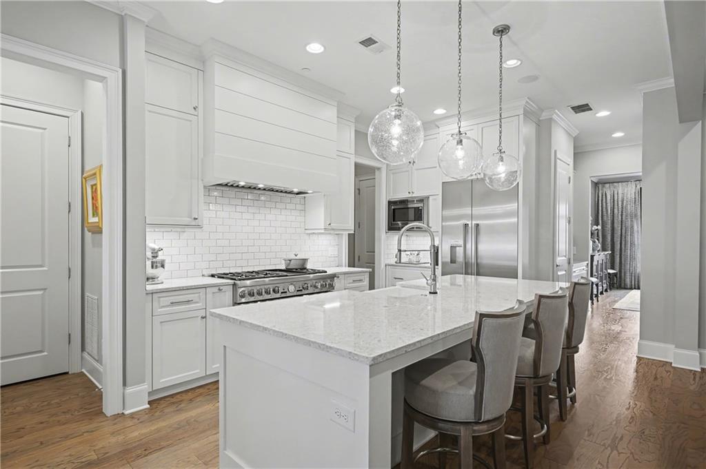 317 Riversedge Drive Atlanta, GA 30339 - Photo 10 of 49 a kitchen with stainless steel appliances a dining table chairs stove and cabinets