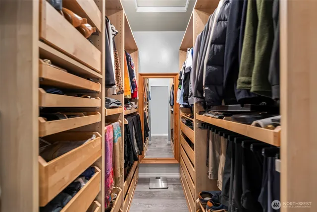 a view of walk in closet with clothes and shoes
